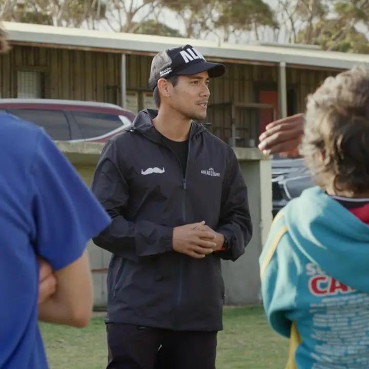 Sport coach providing mental health support to young players.