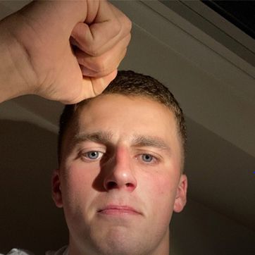 Man holding a triumphant fist to camera.