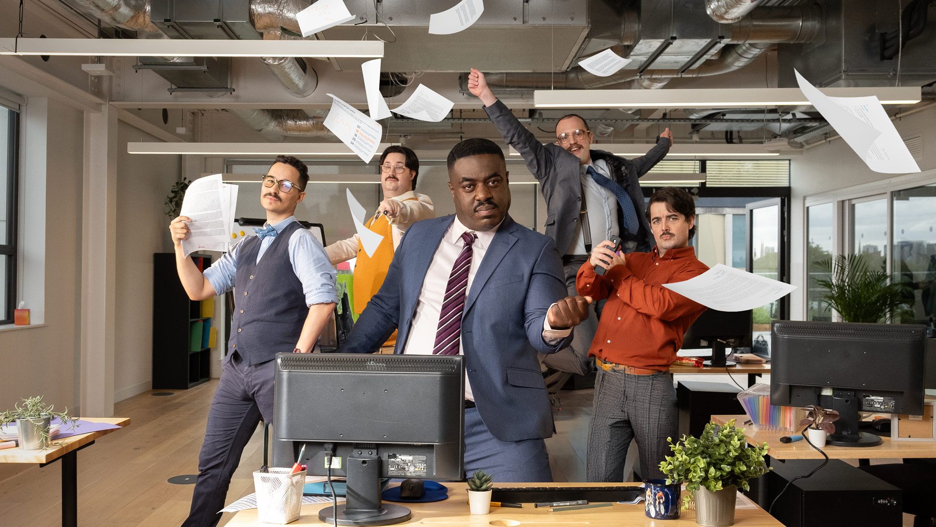 Humorous photo of office workers posing in a dance routine.