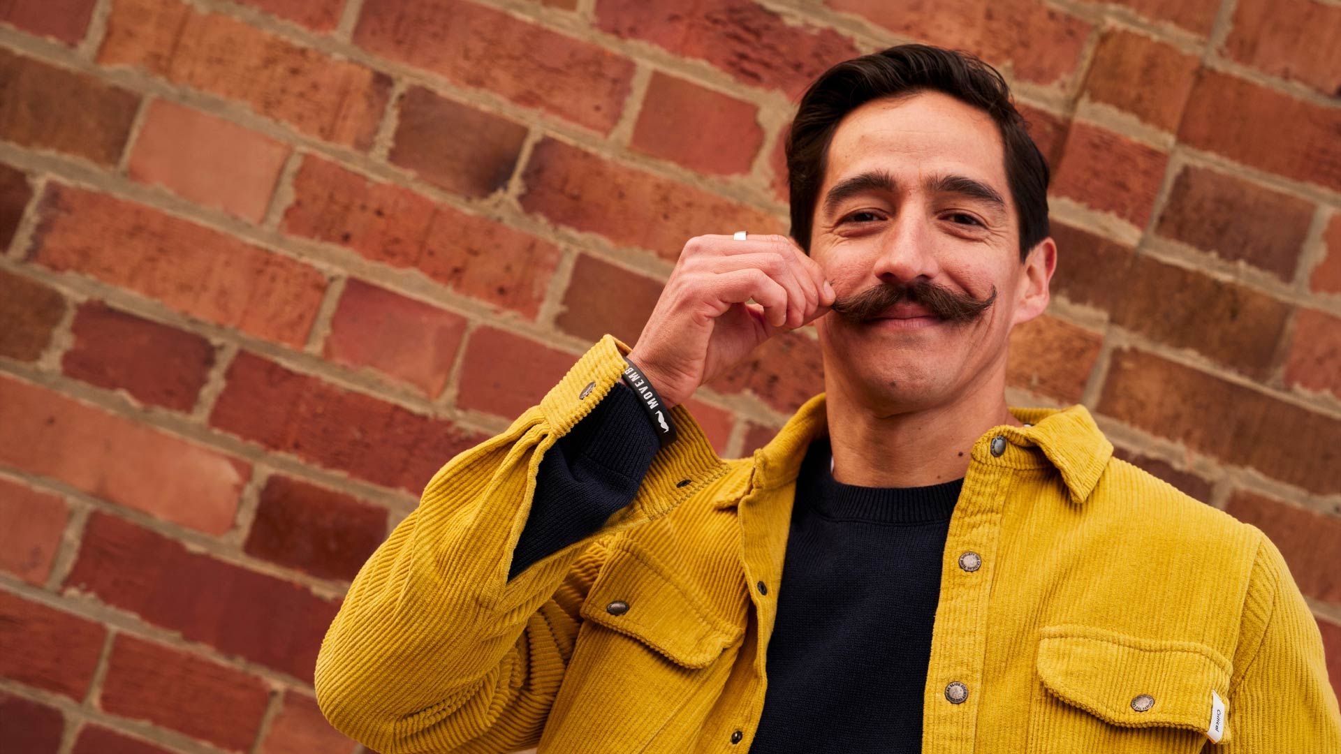 Photo of a man twirling his excellent moustache.