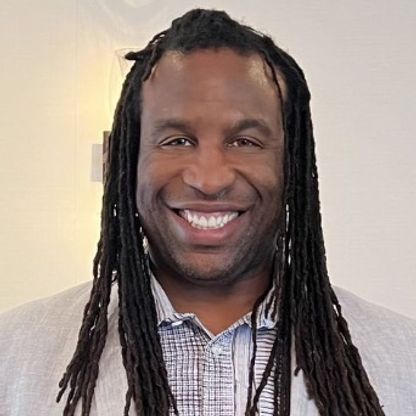 Portrait photo of handsome man smiling warmyl to camera.